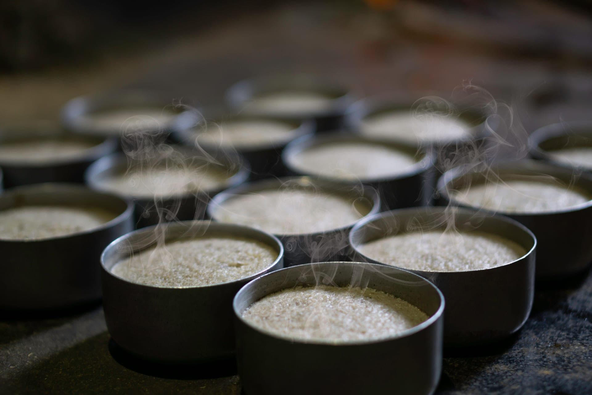 A bowl of freshly cooked white rice with steam rising
